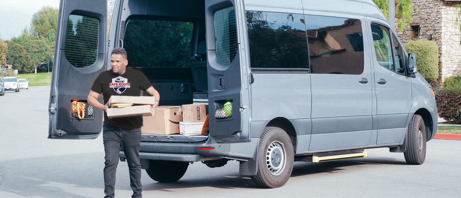 A Safe Route Logistics driver loading parcels from a Sprinter van
